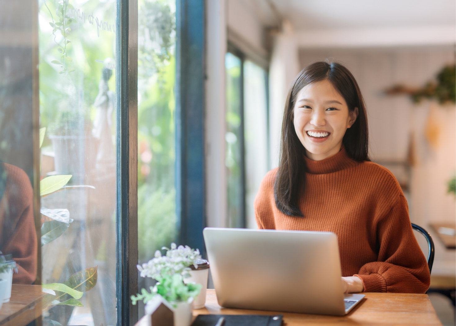 Women happily using her computer.