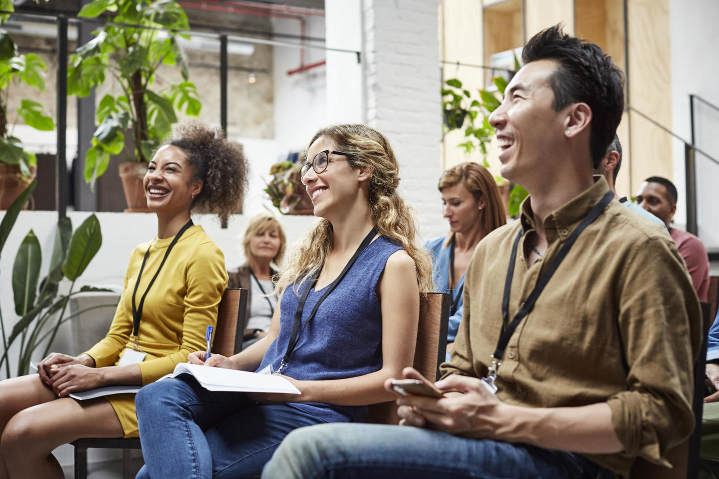 Employees smiling and looking at presentation