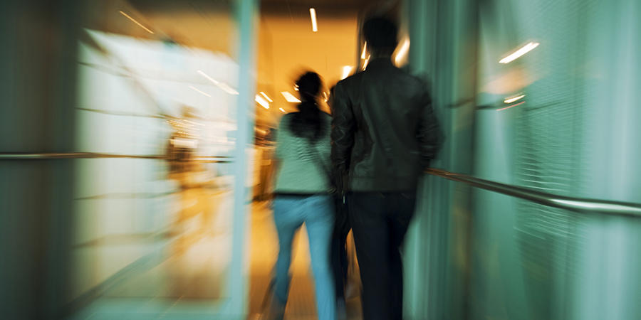 People walking out of building in a blur.