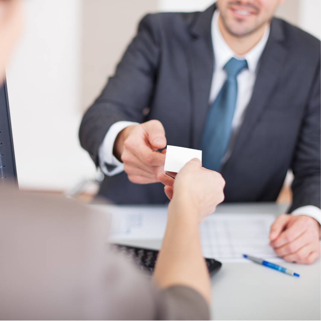 2 persons passing each other a note