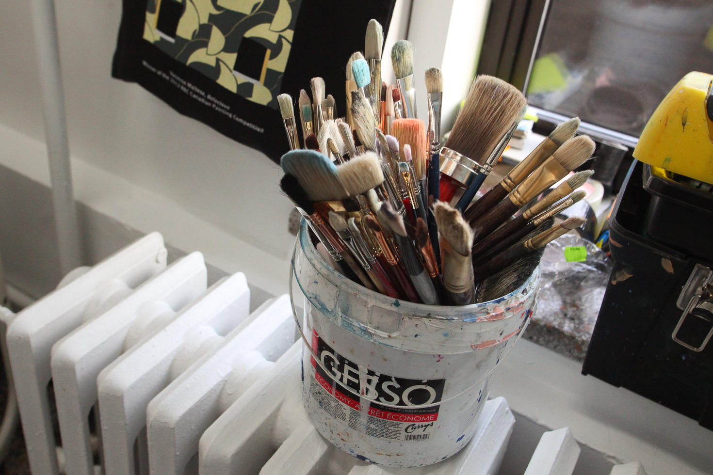 Bucket filled with paint brushes