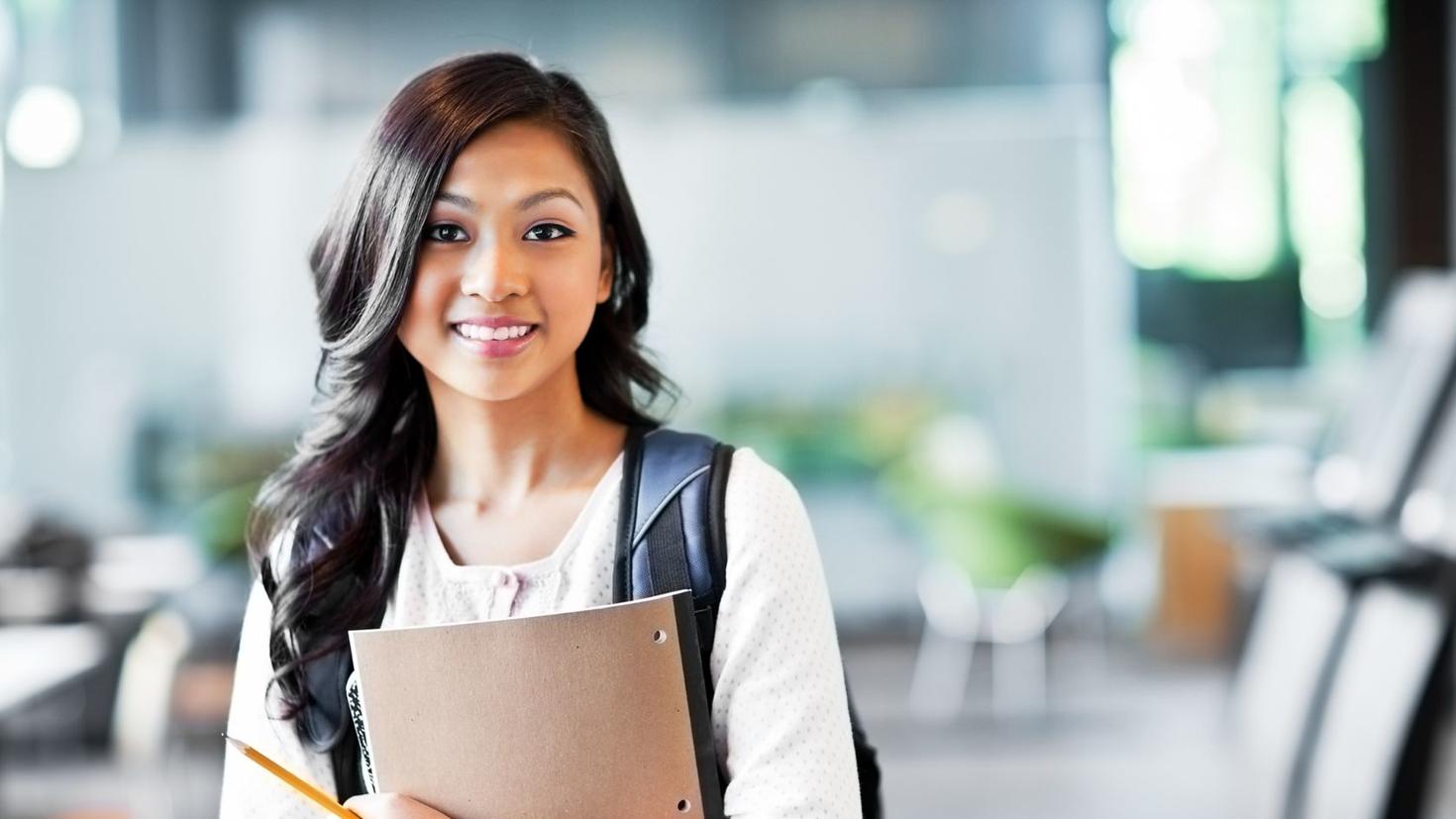 A girl student holding a notebook