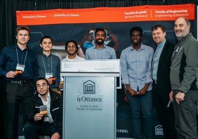 Students on stage with members of the faculty and industry