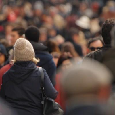 large crowd of people on a sidewalk