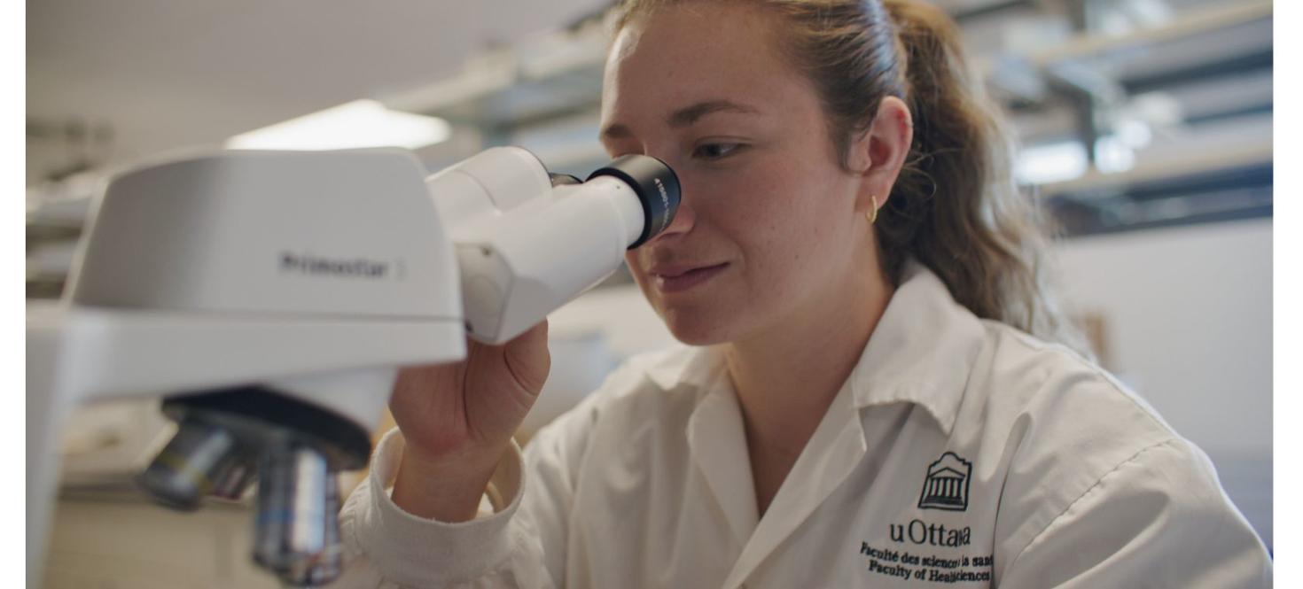 Student looking through microscope