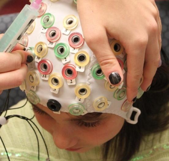 Child with special cap with on head with sensors