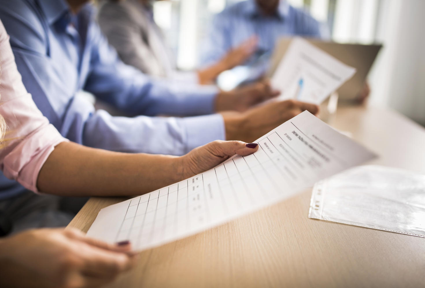 People holding and looking over documents