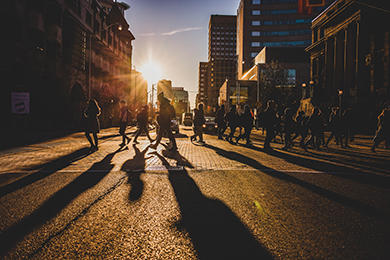 Students crossing the road at sunset