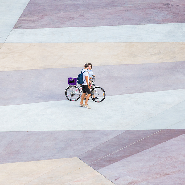 2 sutdents walking with a bicycle